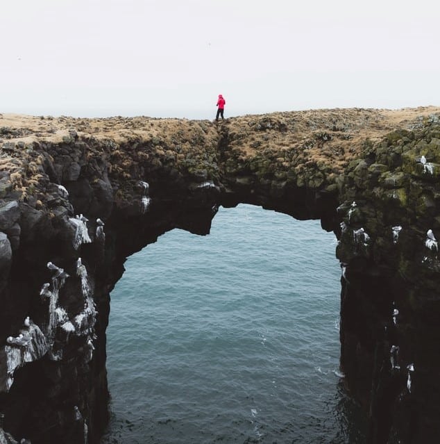 Hombre sobre puente de piedra
